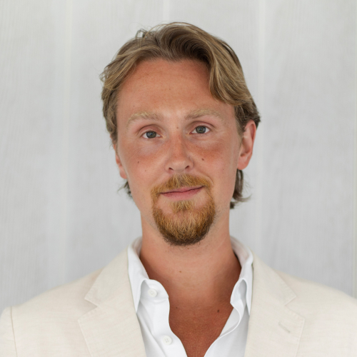 Steven Lubka wearing a cream blazer
